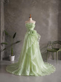 Load image into Gallery viewer, Light Green Strapless Formal Gown with Draped Bodice, Floral Waist Detail and Asymmetrical Flowing Skirt
