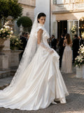 Load image into Gallery viewer, Ivory Statement Wedding Dress with Flowing Skirt and Refined Bridal Silhouette