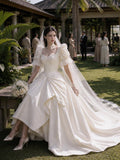 Load image into Gallery viewer, Ivory Statement Wedding Dress with Flowing Skirt and Refined Bridal Silhouette